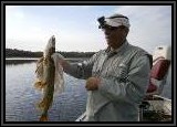 Vinny's Pike.Check out the video camera clipped to his hat. This is a hands free unit with auto focus and sound. The lanyard keeps it from accidently falling into the water.